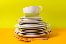 Stack Of Plates, Dishware On Colorful Background.