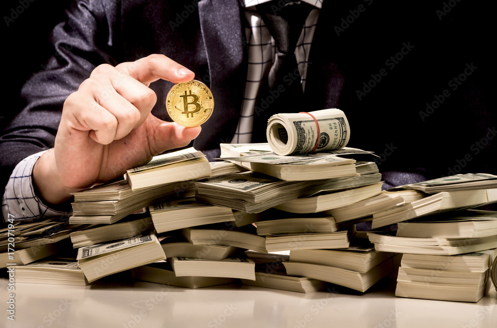Businessman holding bitcoin on black background