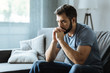 © Viacheslav Yakobchuk - Unhappy bearded man sitting on the sofa