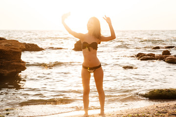 Full length picture of pretty happy brunette woman posing