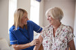 © Monkey Business - Nurse helping senior woman use a walking frame, close up