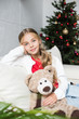 © LIGHTFIELD STUDIOS - child with teddy bear at christmas tree