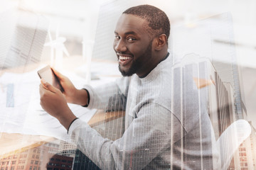 Wall Mural - Cheerful African American holding a tablet