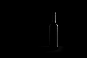 Wall Mural - wine bottle on black background - black and white photo