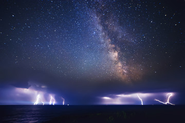 Wall Mural - thunderstorm on sea and milky way night sky