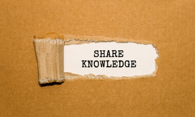 Poster - the text share knowledge appearing behind torn brown paper