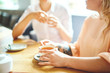© pressmaster - Young friendly girls having tea and talk in cafeteria on weekend
