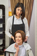 © DenisProduction.com - Woman at the hairdresser smiling. Happy hair salon customer. Which haircut suits you best.
