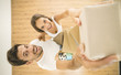 © realstock1 - The smile couple hold a carton boxes and look to the camera. view from above