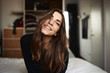 © Guille Faingold/Stocksy - Young woman with long dark hair smiling at camera