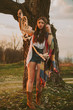 © Volodymyr Matskevych - hipster girl standing near an old tree. the girl is holding the dreamcatcher.