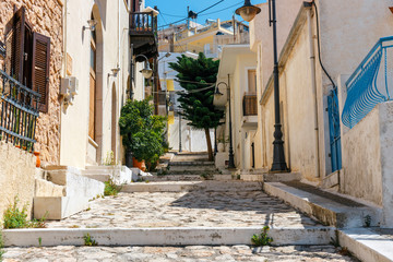 Wall Mural - Street with steps in Sitia town, Crete island, Greece