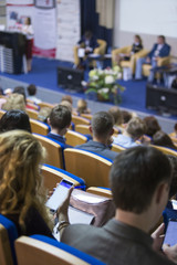 business conferences concept and ideas. back of congress participants listening to the lecturer spea