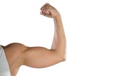 Fototapeta  - Cropped image of sportswoman flexing muscles