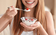 © Africa Studio - Young woman eating yogurt, closeup