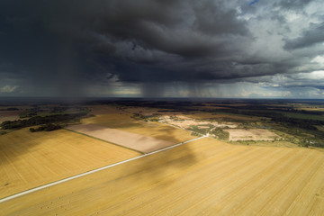 Wall Mural - Rain clouds in latvian countryside.