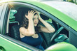 © Artem - Woman in the car in the driving school. Upset. Not passed the exam