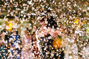 Wall Mural - Confetti falls over dancing wedding couple