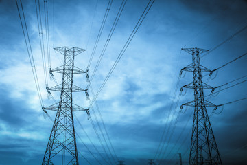 Electricity station. Close up high voltage power lines at sunset.