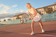 © Africa Studio - Young woman playing tennis on court
