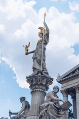 Wall Mural - Statue and fountain of Pallas Athena Brunnen, greek goddess of wisdom, in golden helmet in front of Parliament building in Vienna, Austria