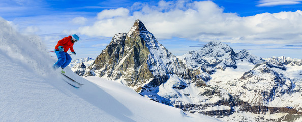 Wall Mural - Skiing with amazing view of swiss famous mountains in beautiful winter snow. Matterhorn, Zermatt, Swiss Alps.