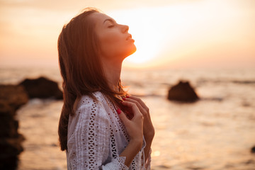 Poster - Side view of Pretty brunette woman in light summer dress