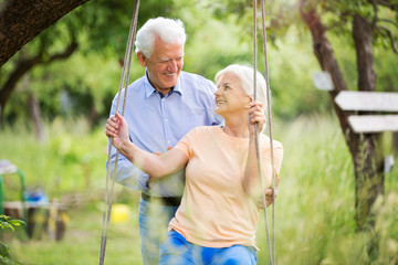 Canvas Print - Senior couple outdoors with tree swing
