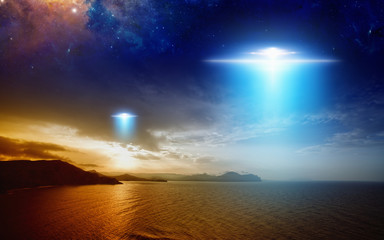 Wall Mural - extraterrestrial aliens spaceship fly above sunset sea