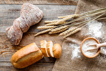 Wall Mural - baking fresh wheaten bread on bakery work table background top view