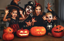 Happy Family Mother Father And Children In Costumes And Makeup On  Halloween.