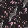 Embroidery oriental seamless pattern with cranes and cherry blossom. Vector embroidered floral patch with bird for clothing design.