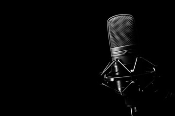 studio condenser microphone, isolated on black. copy space on left