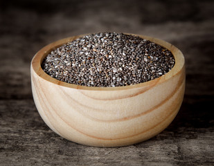 Canvas Print - Healthy Chia seeds in bowl on wooden background.