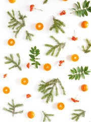 Wall Mural - Pattern of fir branches, tangerines in a cut and rowan. Top view, flat design. Christmas, New Year background.