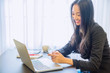 © nuwatphoto - Young business woman using smart phon.