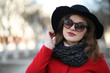 © alexkich - Pretty girl on a walk in red coat in the city