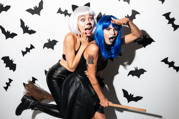 Wall Mural - Emotional young women in halloween costumes