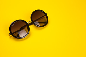 Wall Mural - Stylish sunglasses on yellow background