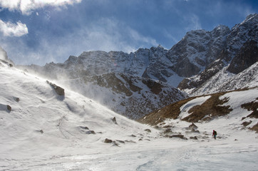 Man looking away and thinking in snow mountain hill scenery