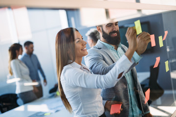 Picture of designers sticking notes in office