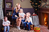 Fototapeta Panele - Mother reading for children at Christmas time