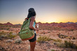 © Joshua Resnick - female african american hiker watching sunset in nevada desert at valley of fire