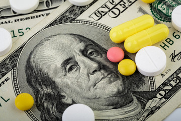 Wall Mural - Medicine pills or capsules, vitamin with money, dollar. Medical or pharmacy prescription for health. Business, finance concept. Cost of the healthy life. Money and pharmacy still life