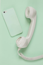 Mobile Phone And Old Fashioned Handset On Pale Mint Background