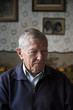 © Jovana Milanko/Stocksy - Portrait of a senior man having hearing aid in his ears