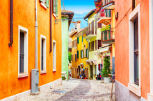 Small Town Narrow Street View With Colorful Houses In Malcesine, Italy During Sunny Day. Beautiful Lake Garda.