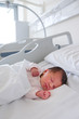 © Giorgio Magini/Stocksy - First Days of a Newborn Baby Girl Sleeping in Hospital Room