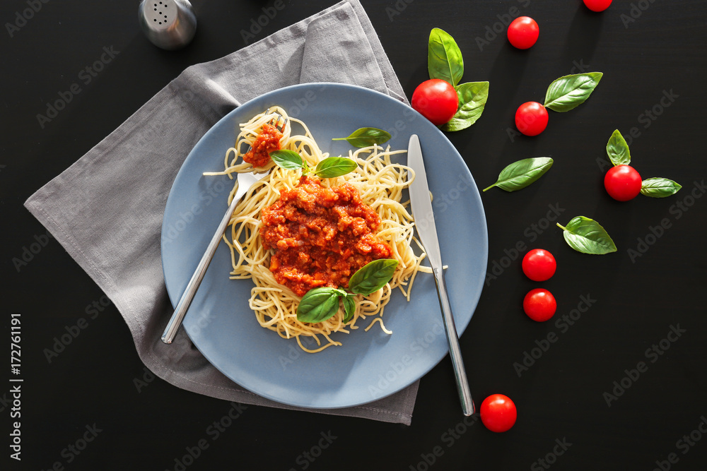 PLate of delicious pasta with bolognese sauce on table