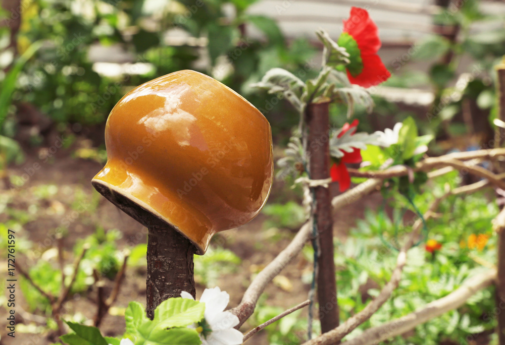 Crock pot on fence. Waste recycling concept